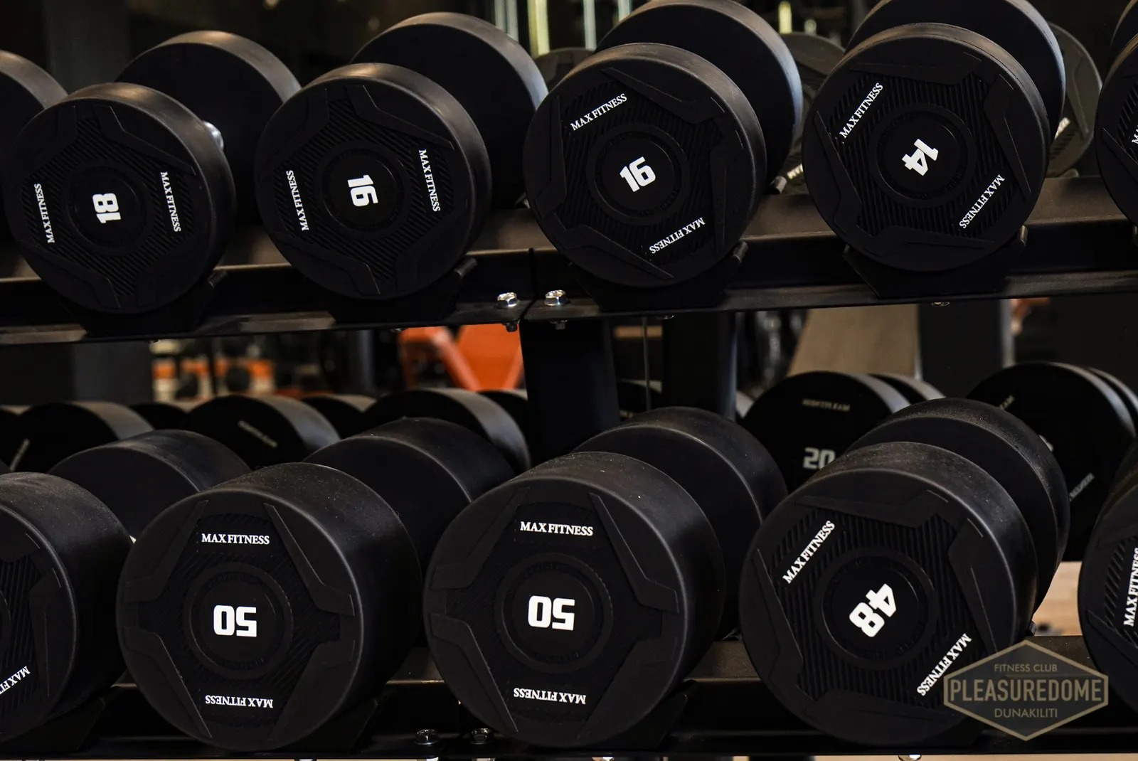 Prémium Max Fitness gumírozott súlyzók közeli képe a Pleasuredome állványán